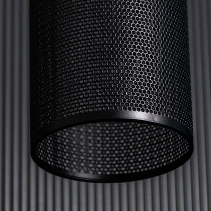 Closeup of black woven pendant light highlighting perforated texture layered weaving pattern and warm ambient light detail.