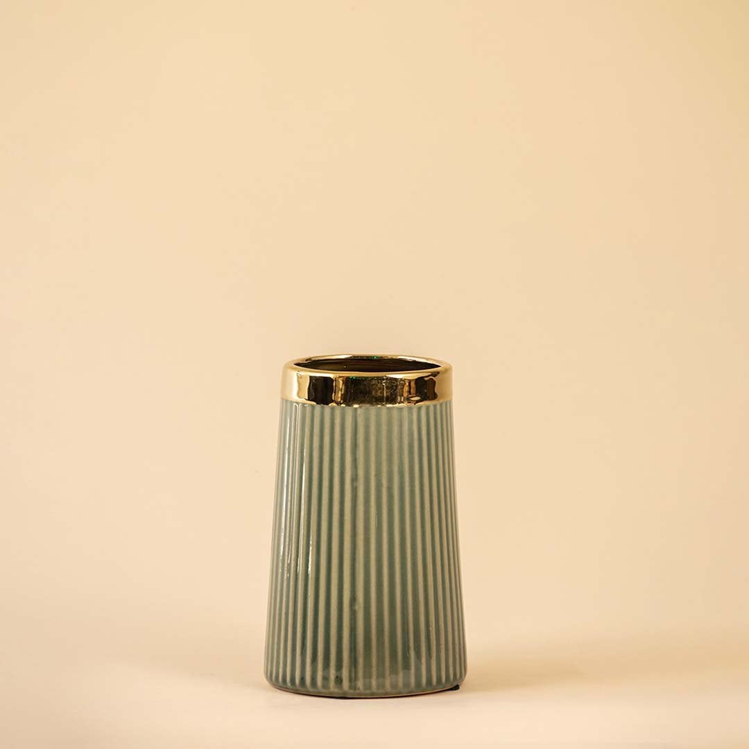 Stylish vertical-grooved vase in soft green with a polished gold rim showcased on a white backdrop emphasizing its modern design and smooth finish.