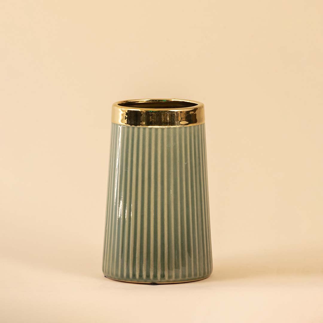 Sage green ceramic decorative vase with gold rim and fluted design for contemporary shelf styling and home decor.