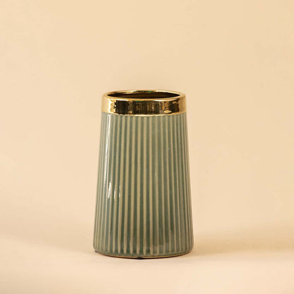 Sage green ceramic decorative vase with gold rim and fluted design for contemporary shelf styling and home decor.