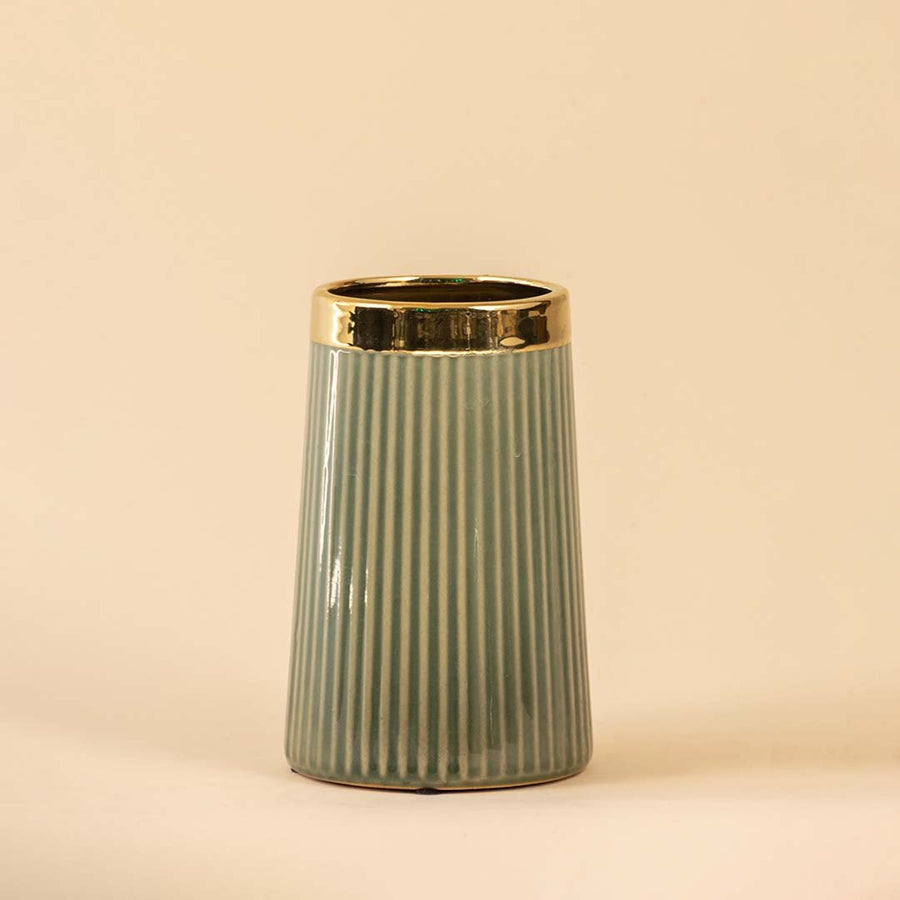 Sage green ceramic decorative vase with gold rim and fluted design for contemporary shelf styling and home decor.