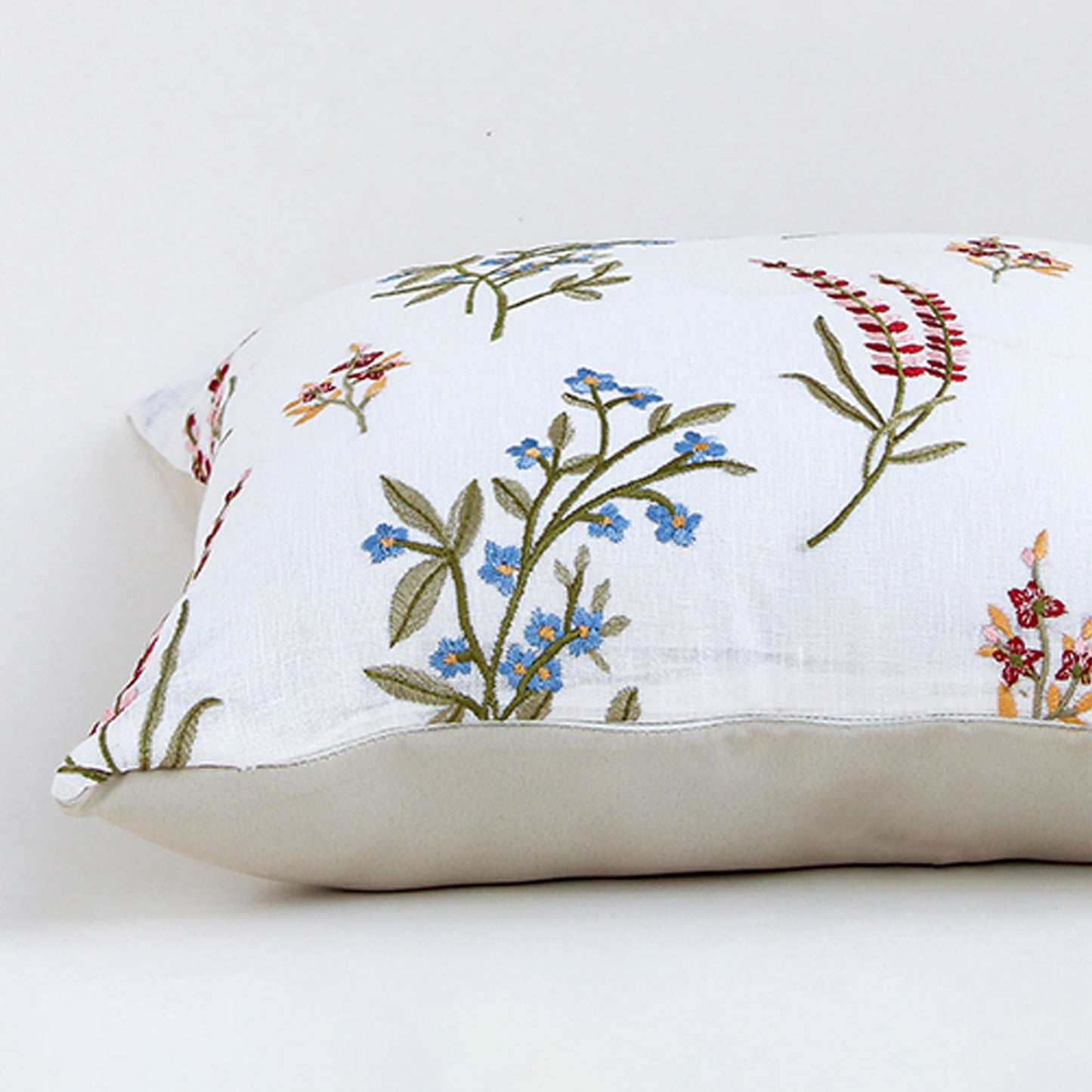 Closeup view of cotton cushion embroidery showing colorful stitched floral patterns and textured fabric details ideal for adding soft charm to home decor.