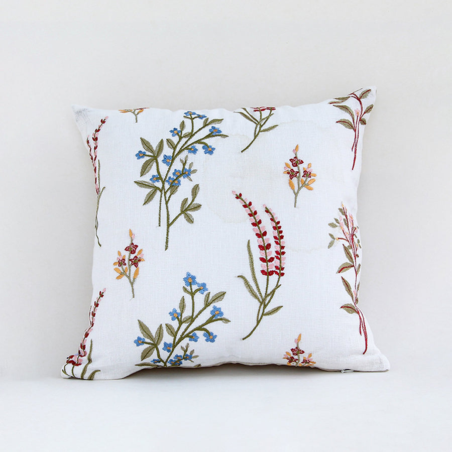 White cotton cushion cover with colorful botanical leaf print for sofa bedroom seating and elegant home decor styling.