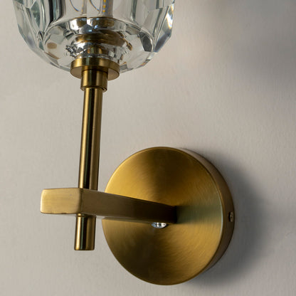 Closeup of gold metal crystal wall light for luxury bedroom hallway and elegant modern decor styling spaces.