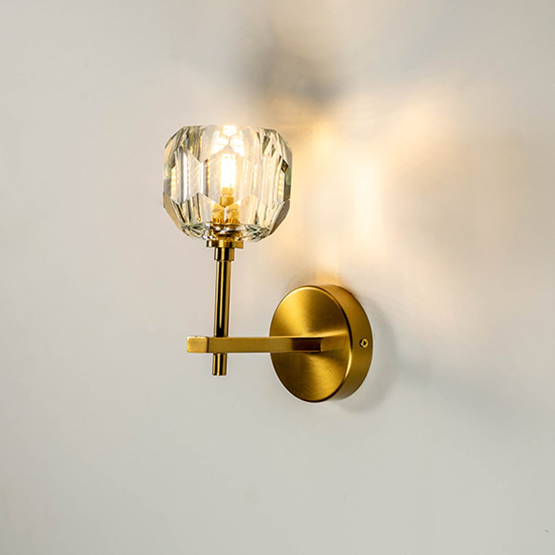 Crystal wall light glowing warmly on white background adding elegance and sophistication to contemporary interiors.