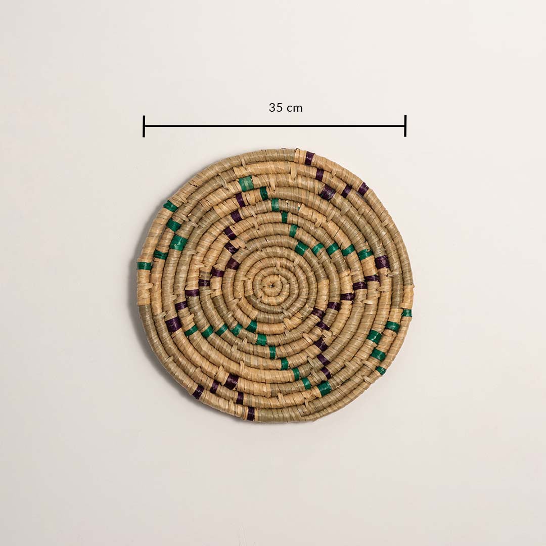 A handwoven teal mustard and natural rattan wall decor plate displayed on a white background clearly showing a diameter of 30 cm for accurate measurement and wall placement.