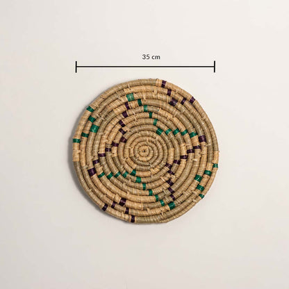 A handwoven teal mustard and natural rattan wall decor plate displayed on a white background clearly showing a diameter of 30 cm for accurate measurement and wall placement.