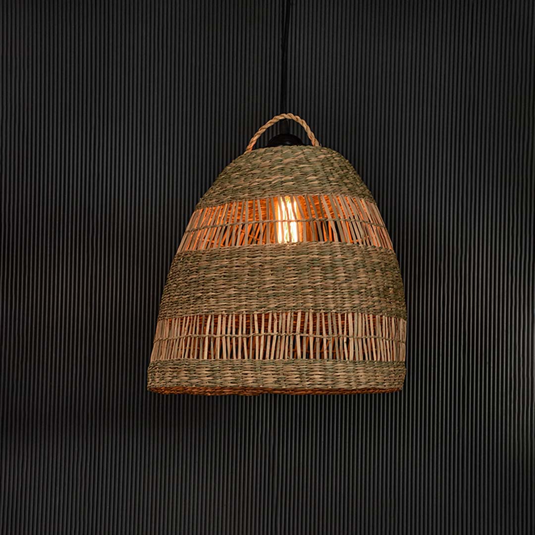 Rattan pendant light with dome shaped woven shade and braided top displayed on black background for home decor.