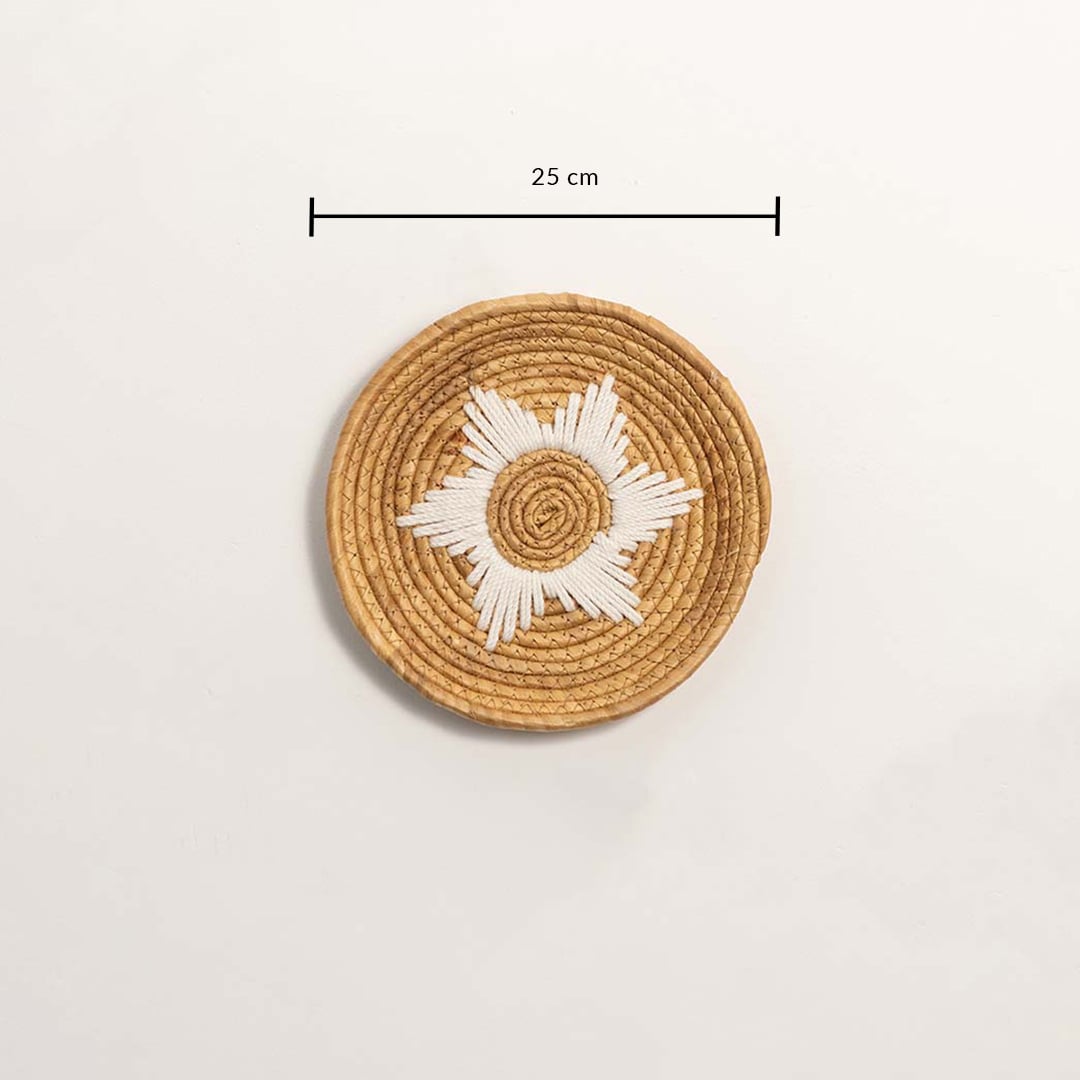 Medium round woven wall basket measuring 27 cm in diameter featuring natural beige coils and white accents displayed on white.