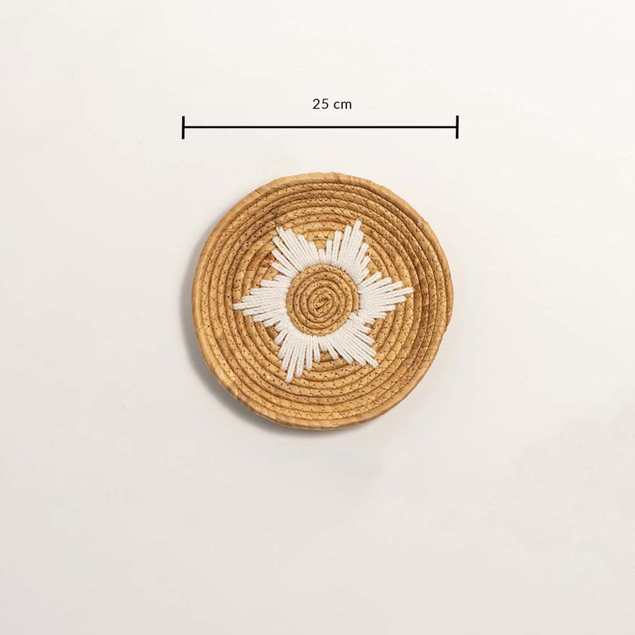 Medium round woven wall basket measuring 27 cm in diameter featuring natural beige coils and white accents displayed on white.