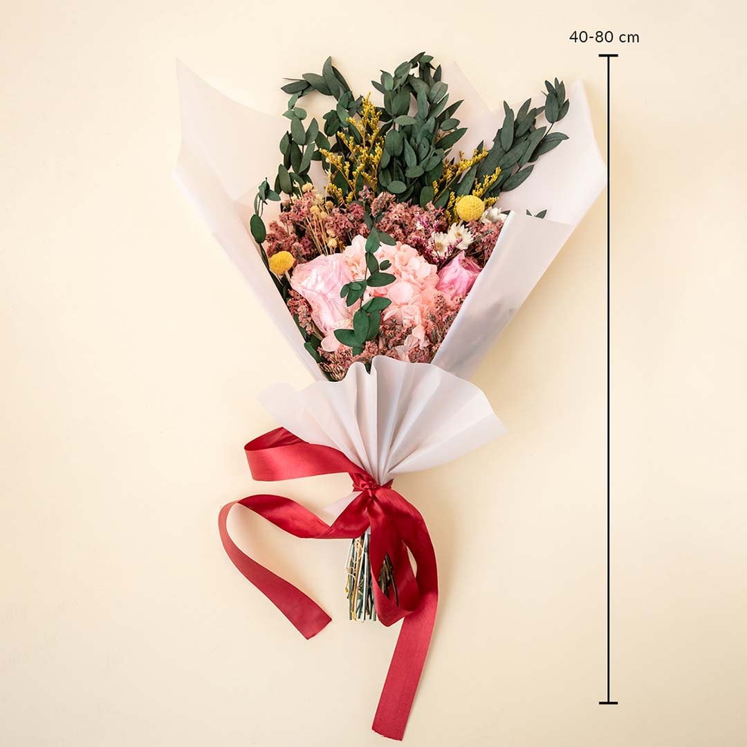 Elegant dried flower bouquet with infinity rose hydrangea eucalyptus billy ball 40 to 80 cm tall wrapped in white paper.