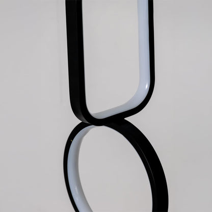 Closeup of black and white metal dual shape hanging light showing smooth edges and premium modern decor detailing.
