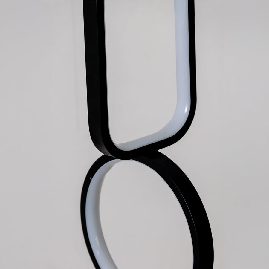 Closeup of black and white metal dual shape hanging light showing smooth edges and premium modern decor detailing.