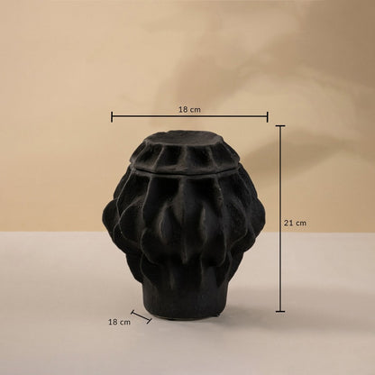 Black handcrafted ceramic vase with sculptural texture displayed on a neutral surface measuring 21 cm in height and 18 cm in width.
