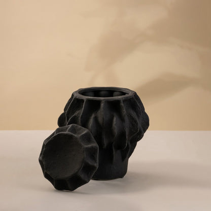Set of black ceramic decorative vases with sculptural textured design for artistic tabletop styling and modern home decor.
