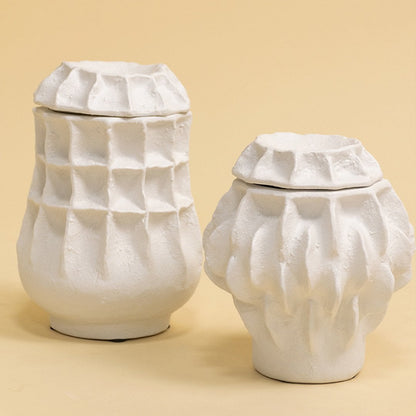 Set of white sculptural vases in modern organic shapes arranged together for a refined artistic decor display.