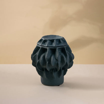 Black ceramic decorative vase with sculptural textured pattern for modern tabletop styling and contemporary home decor.