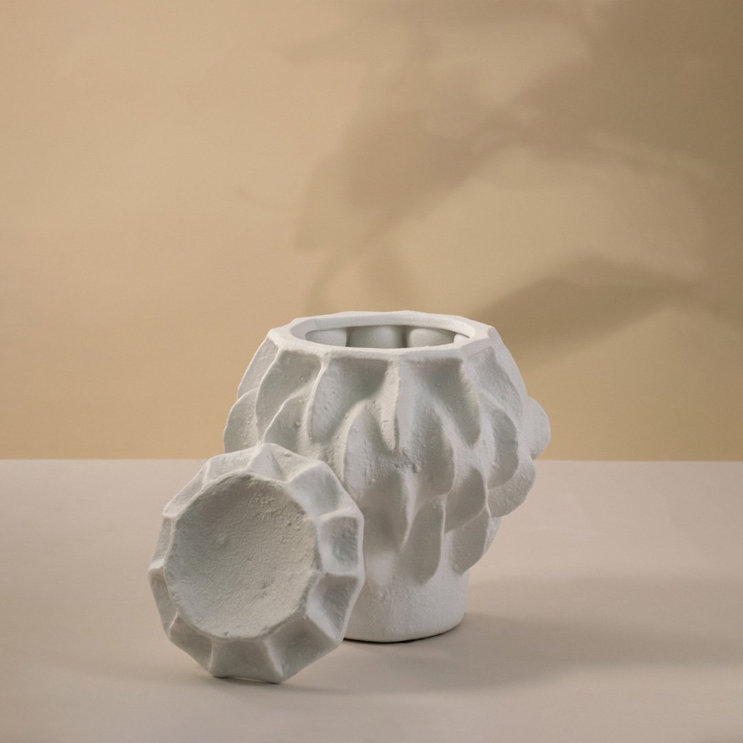 White ceramic decorative vase with geometric textured design for contemporary tabletop styling and home decor.