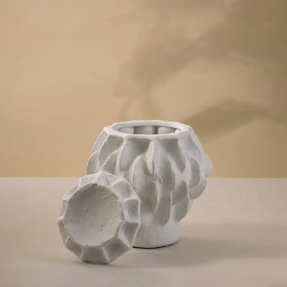 White ceramic decorative vase with geometric textured design for contemporary tabletop styling and home decor.