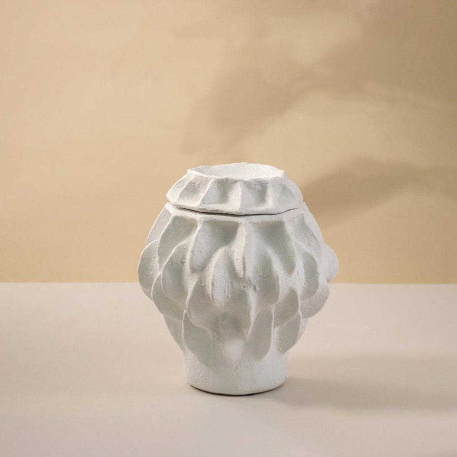 Matte white vase displayed on white background emphasizing its organic sculptural texture and smooth handcrafted finish.
