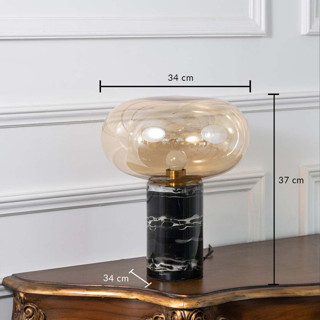 Amber glass and black marble table lamp on white background showing height 37 cm and width 34 cm ideal for bedroom or study decor.