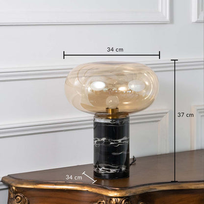 Amber glass and black marble table lamp on white background showing height 37 cm and width 34 cm ideal for bedroom or study decor.