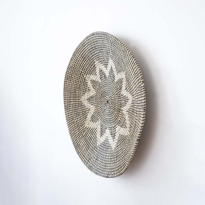 Side view of large handwoven wicker basket wall decor showing woven texture and depth for modern boho home desig