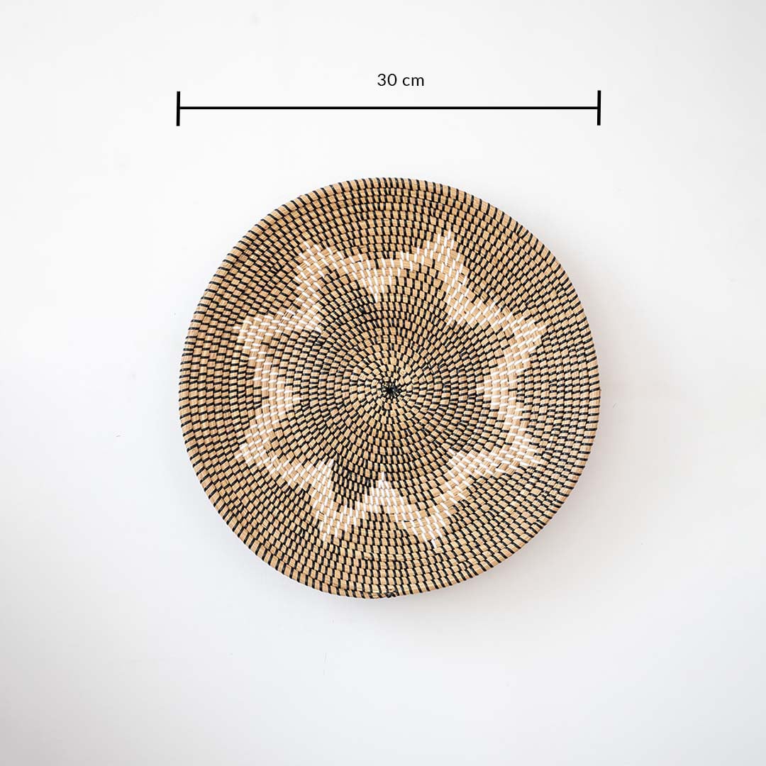 Circular woven wall basket with geometric star motif in natural tones showing 30 cm diameter ideal for accent wall styling.