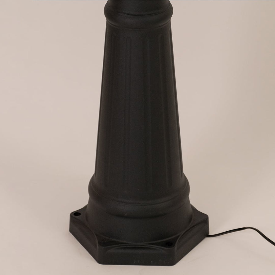 Detailed closeup of black lamppost lantern highlighting metal frame and clear glass for traditional garden and patio lighting.