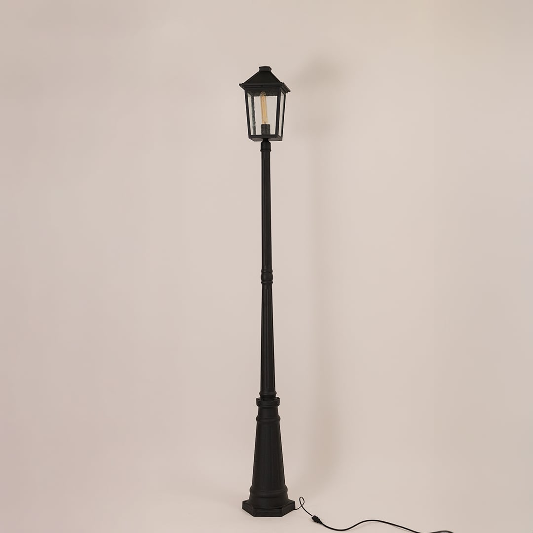 Black outdoor lamppost with clear glass lantern shown on a bright white background with lights off for a classic outdoor look.