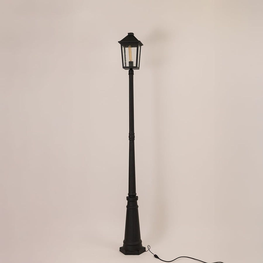 Black outdoor lamppost with clear glass lantern shown on a bright white background with lights off for a classic outdoor look.