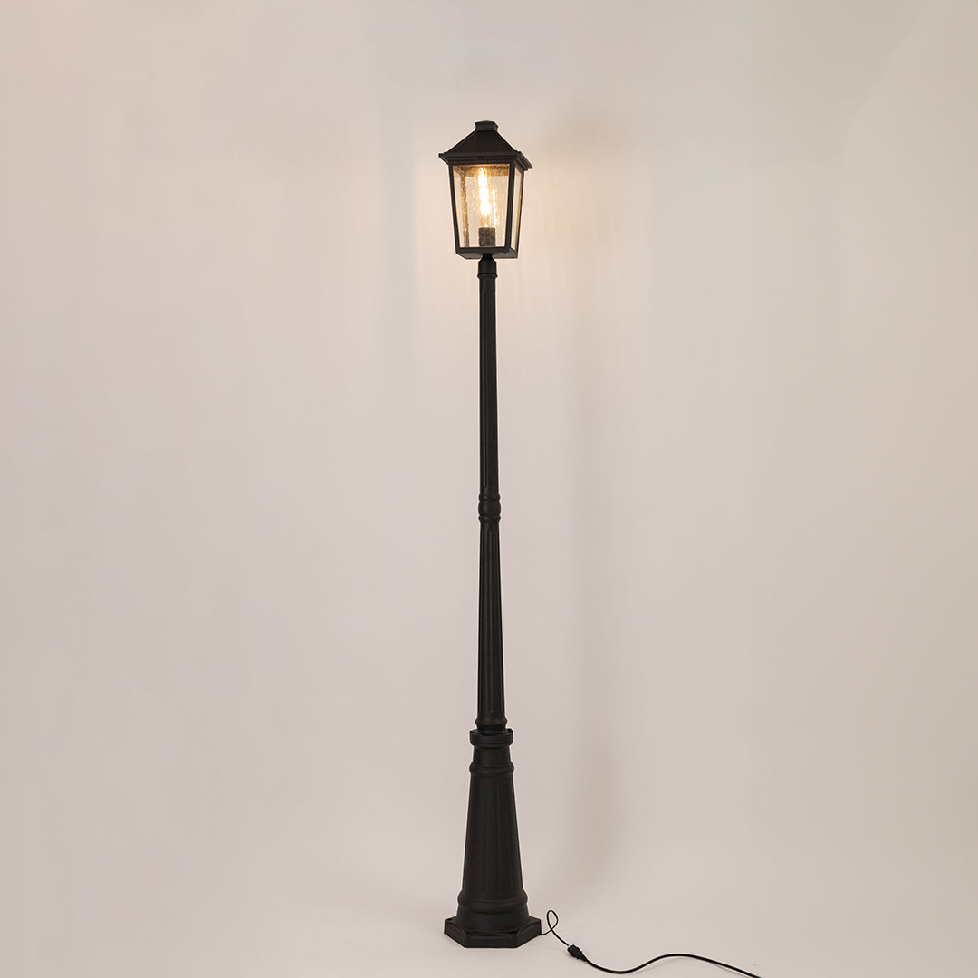 Vintage black outdoor street lamp with glowing lantern for luxury exterior decor styling use.
