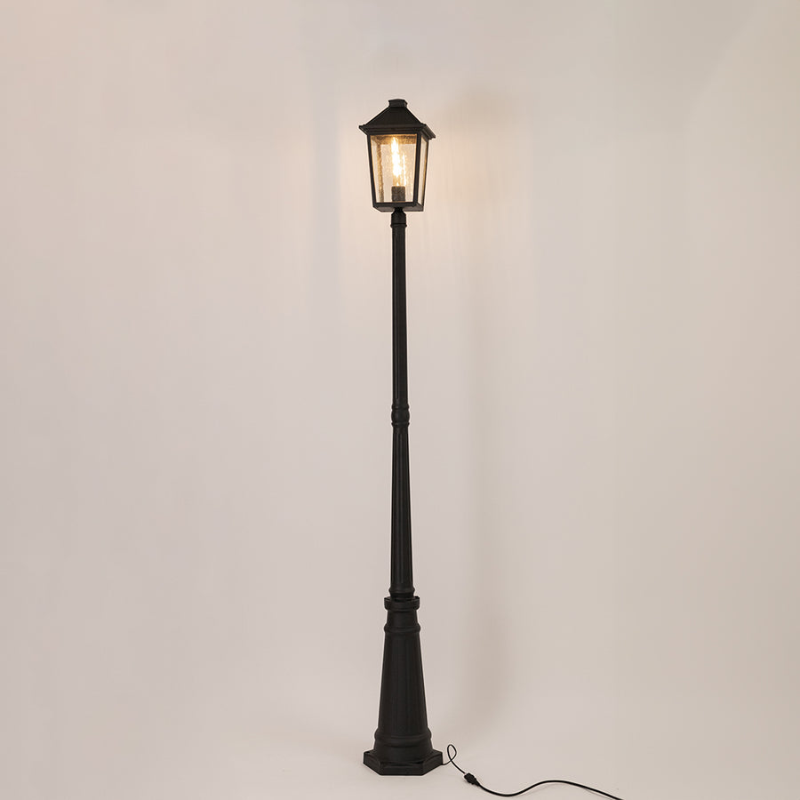 Vintage black outdoor street lamp with glowing lantern for luxury exterior decor styling use.