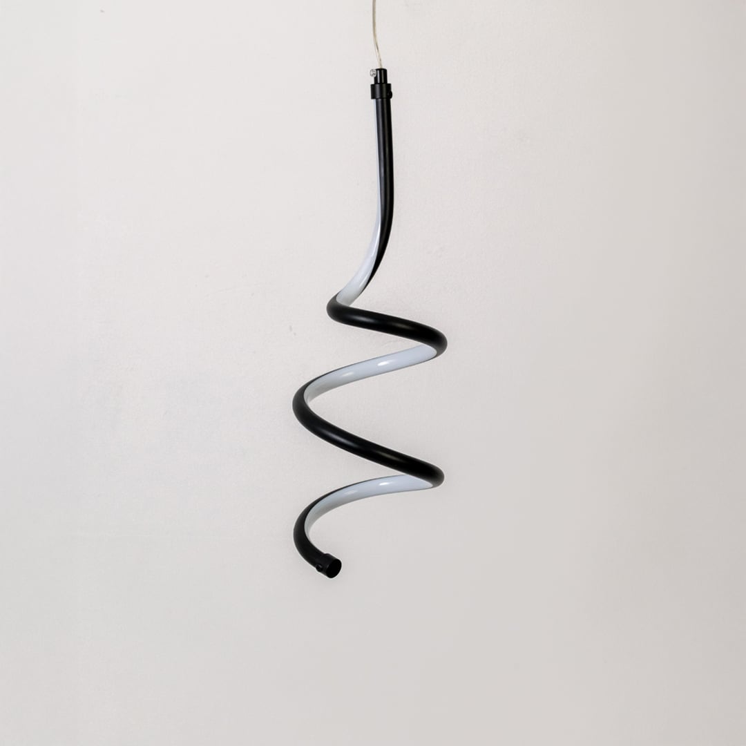 Modern black and white metal spiral hanging light shown switched off on white background for minimal wall decor.