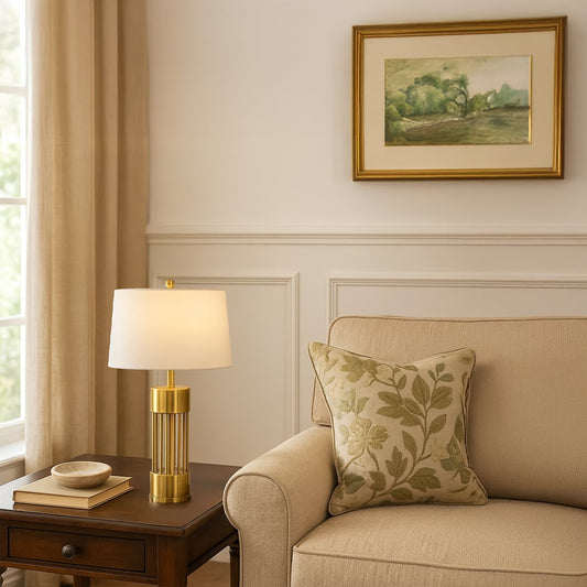 Gold lamp on side table with light on and neutral sofa with framed art background for modern chic décor.