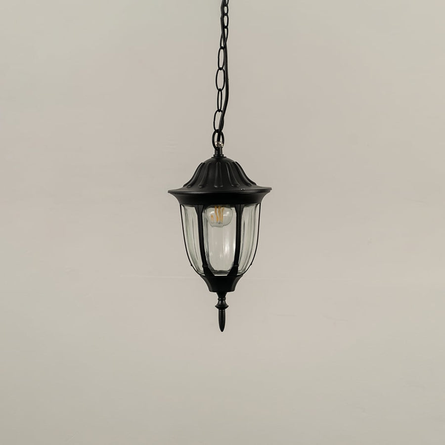Black outdoor hanging lantern light turned off on white background highlighting design and material finish.