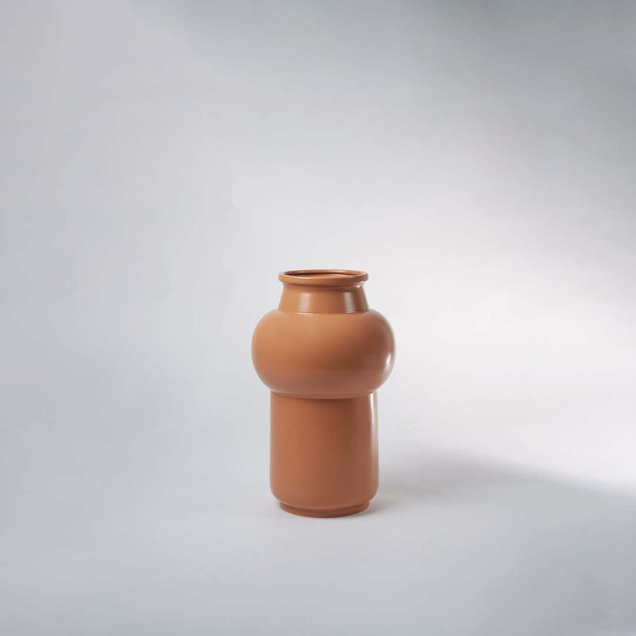 Brown ceramic vase on neutral background emphasizing its clean lines and elegant finish perfect for minimalistic decor styling.
