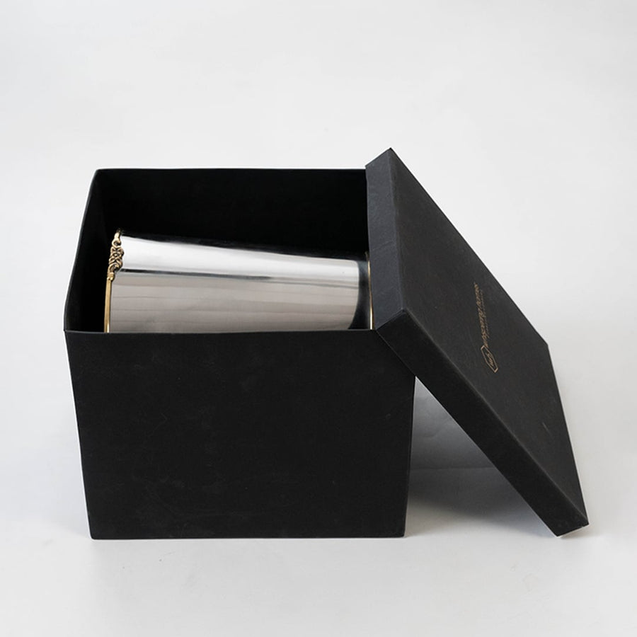 Stainless steel silver cup inside sleek black box packaging for premium presentation and safe storage.