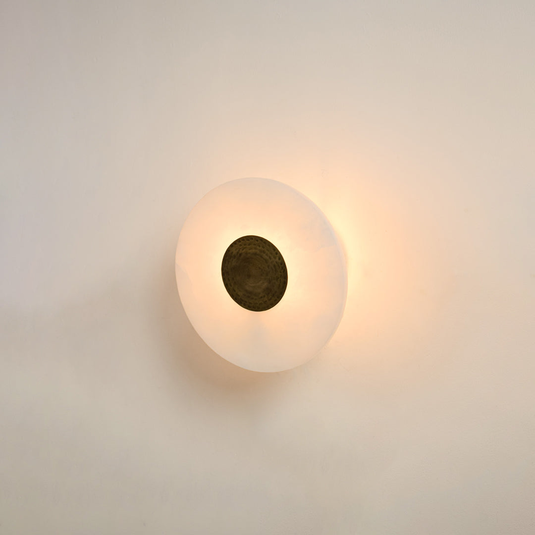 Modern white marble wall light with warm ambient glow for elegant hallway and luxury decor styling spaces.