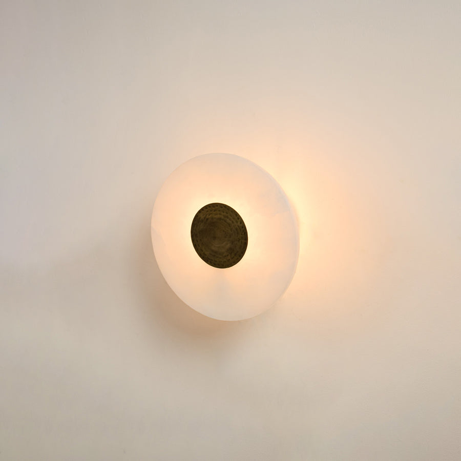 Modern white marble wall light with warm ambient glow for elegant hallway and luxury decor styling spaces.