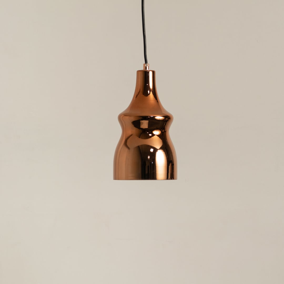 Copper metal pendant light on a white background with the light off highlighting its sleek modern shape and polished surface.