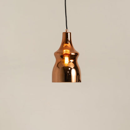 Copper metal pendant light glowing softly on a clean white background showcasing its modern reflective curved design.