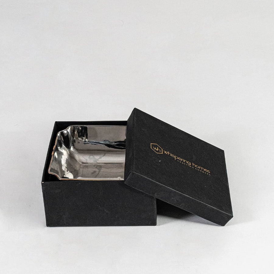 Silver decorative bowl presented inside a branded black gift box showing premium packaging suitable for corporate or festive gifts.