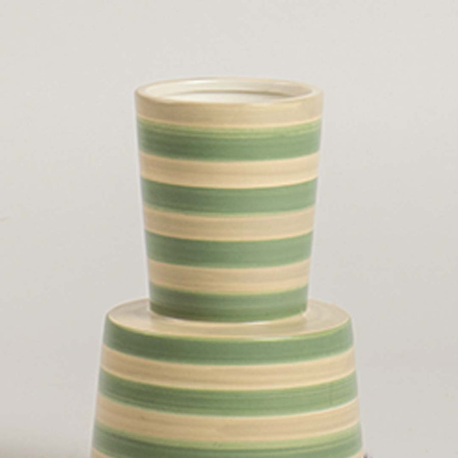 Closeup view of a green and beige striped ceramic vase highlighting its smooth texture  tapered form  and clean handcrafted detailing.