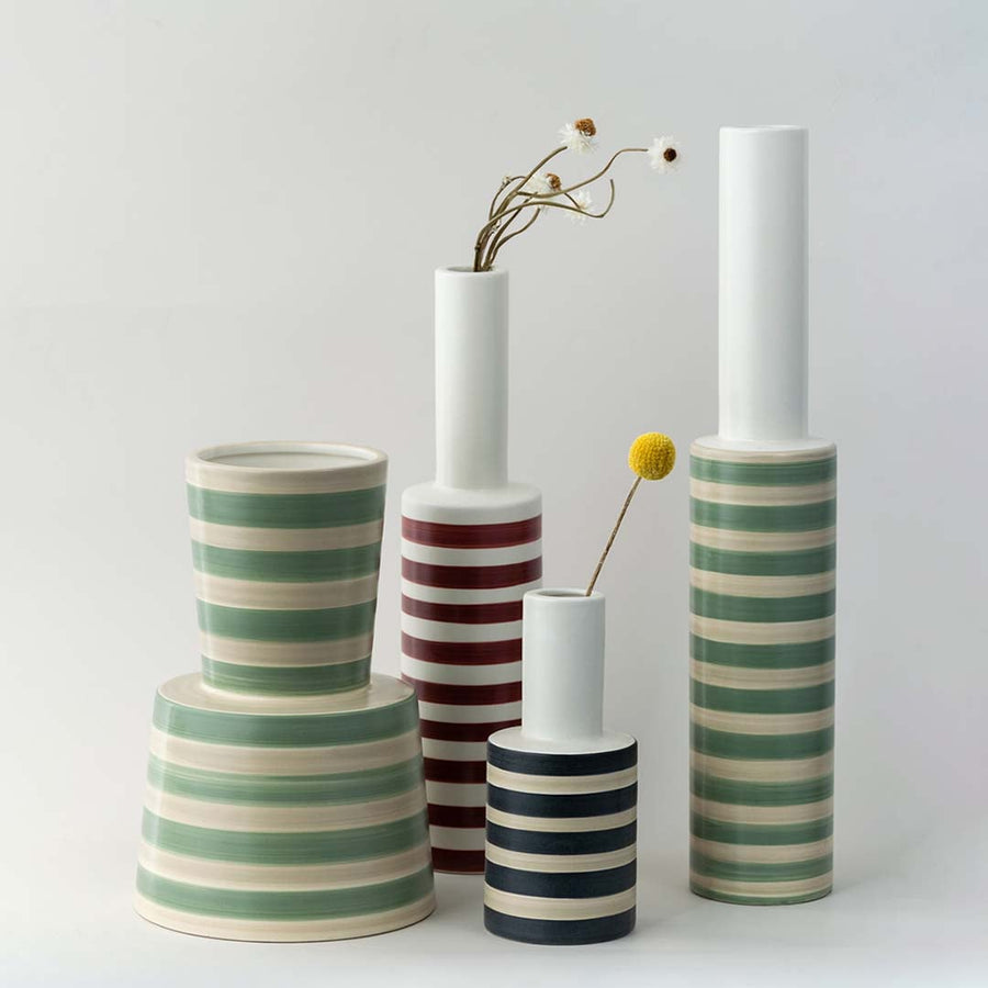 A stylish striped vase displayed with complementary decor pieces creating a coordinated modern look perfect for enhancing interior styling.