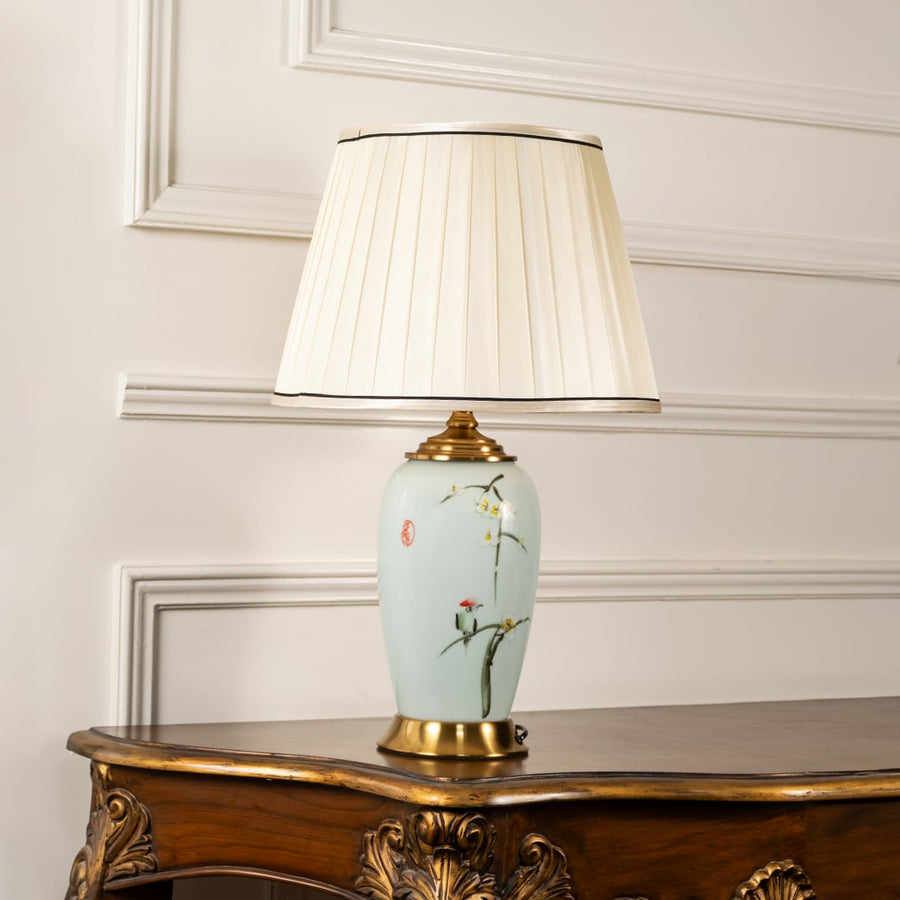 Unlit floral ceramic lamp with cream shade and gold base retains artistic beauty and decorative appeal making interiors look effortlessly elegant.