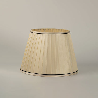 Table lamp shade featuring a pleated cream fabric design that adds a soft warm glow and elegant touch to any modern interiors.
