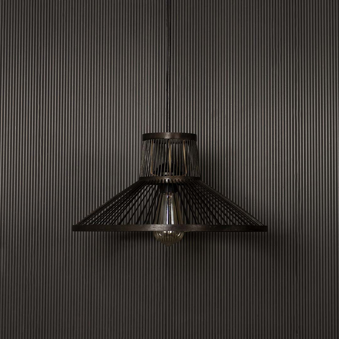 Black wire pendant light on dark background highlighting its geometric cone shape and matte metal finish.