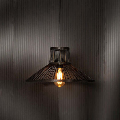 Cone black wire pendant light glowing softly on black background reflecting industrial charm and warm ambience.