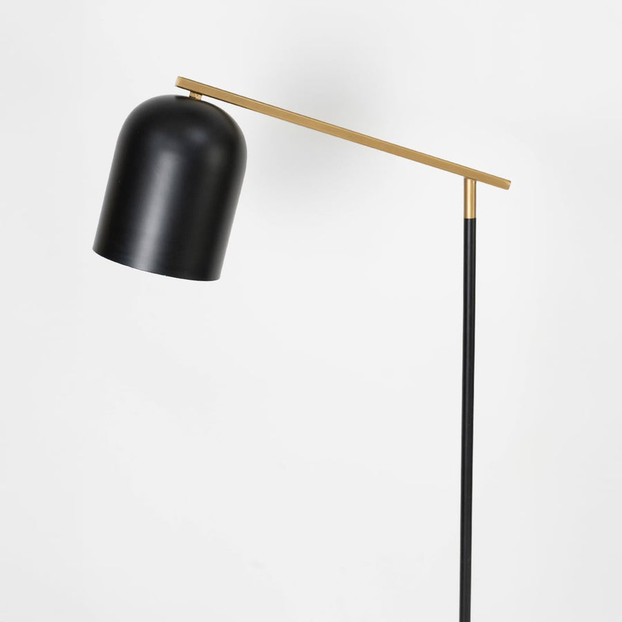 Minimal black circular metal base of modern floor lamp designed for stability and sleek interior lighting setups.